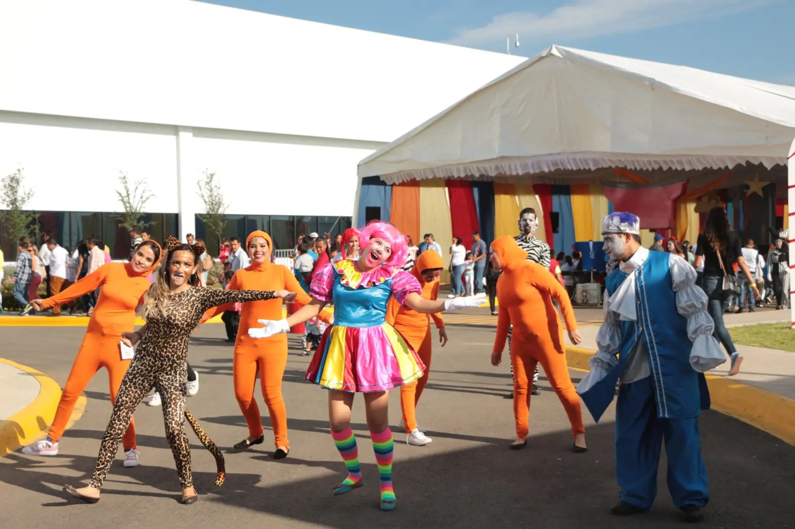 Personajes y animadores interactuando con los asistentes al aire libre durante el evento